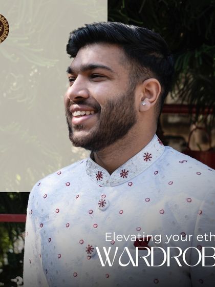 Elevating your ethnic wardrobe. A happy client smiling in his white sherwani with red embroidered details.