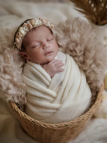 There is a timeless beauty in simplicity. This classic newborn portrait, with its soft, neutral tones and a cozy woven basket, focuses purely on the peaceful innocence of your sleeping baby.