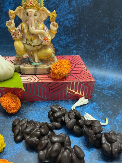 For something truly unique, I make these chocolate-covered crunchy almond clusters, shaped to resemble a garland of modaks.