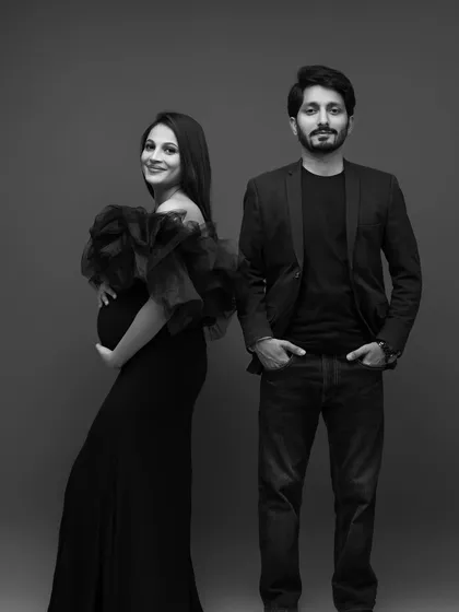 A stylish and confident couple's portrait in black and white, giving it a classic, cinematic feel.
