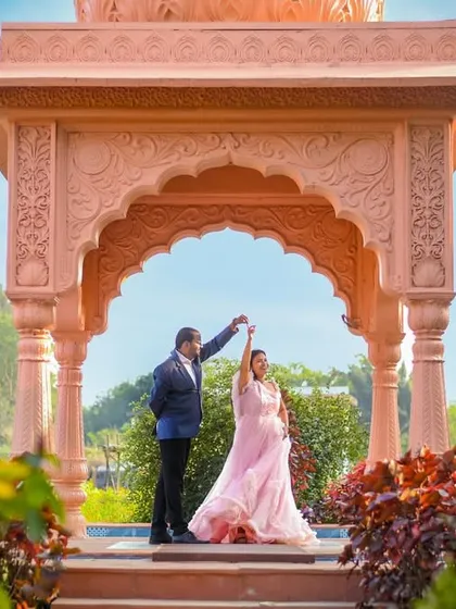 A pre-wedding portrait that feels like a scene from a fairytale. The couple dances under a grand, ornate archway, showcasing how we can use stunning architecture to frame your love story.