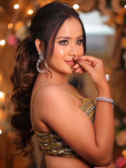 A side profile showing off the beautiful curls in the ponytail and the flawless makeup. This look is perfect from every angle.