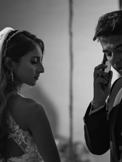 A candid, story-telling moment from a wedding shoot. This black and white photo feels like a still from a film, capturing a moment of quiet drama.