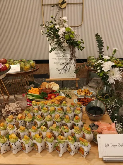 A stunning display of our Gold Dragon Sushi rolls, a centerpiece of an Asian-inspired grazing table. This shot emphasizes our skill in creating visually appealing and delicious sushi, perfect for any event.