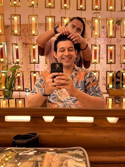 Getting a quick touch-up from the hair stylist between takes. Long shoot days mean you have to stay fresh and camera-ready at all times.