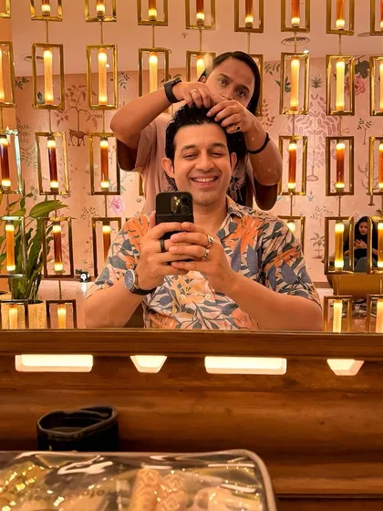 Getting a quick touch-up from the hair stylist between takes. Long shoot days mean you have to stay fresh and camera-ready at all times.