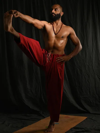 Utthita Hasta Padangusthasana A, the first stage of the extended hand-to-big-toe pose. This balancing asana strengthens the standing leg and core while stretching the hamstring of the raised leg.