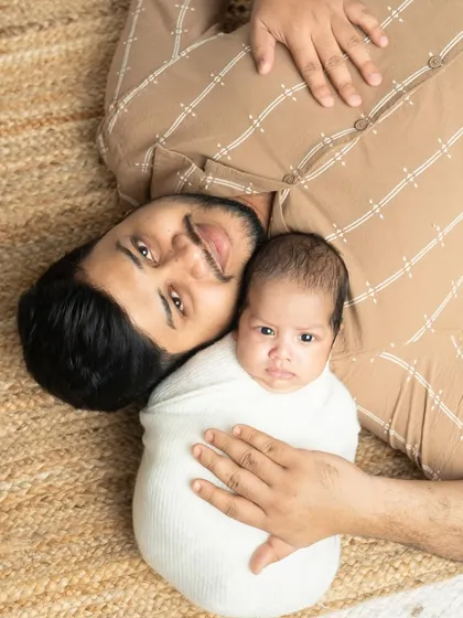 Father and baby, chest to chest. This overhead shot is a sweet and simple way to show the loving bond between a dad and his newborn.