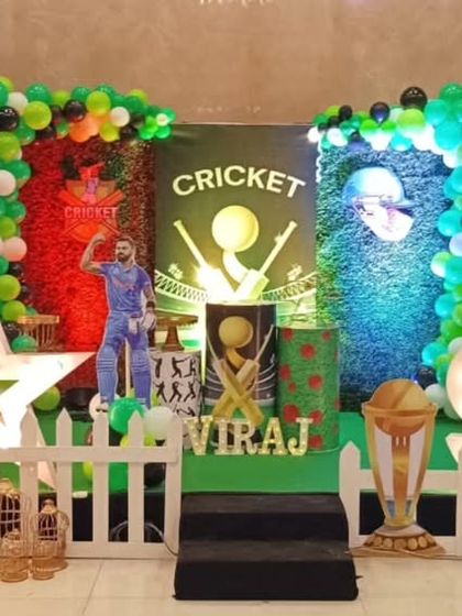 A full-scale cricket theme party for a 9th birthday. The stage is designed to look like a stadium, with player cutouts, trophies, and a large light-up star.