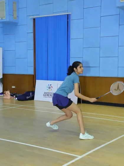 A young player lunges forward for a net shot, showcasing her agility. Our tournaments are a platform for students to apply their trained skills.