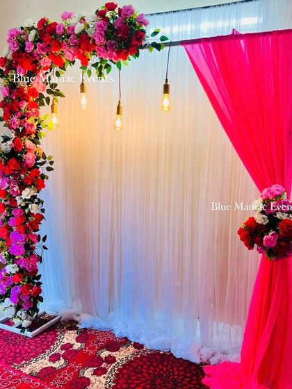The full setup of the floral arch backdrop, showing its scale and how it can transform a space.