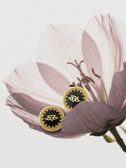 A creative shot of the Chevron Studs by JJ Valaya, nestled in a delicate flower. These studs are perfect for adding a touch of designer elegance to your daily wardrobe.