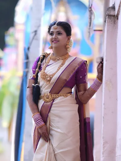 For my beautiful South Indian brides, it's all about timeless elegance. This Murtham look features glowing skin, defined eyes, and makeup that enhances her features while perfectly matching the grandeur of her silk saree and temple jewellery.