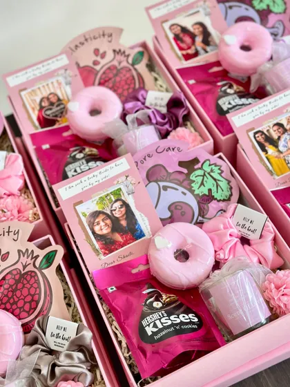 More bridesmaid hampers ready to make someone's day! This version includes a donut soap, Hershey's Kisses, a face mask, a scented candle, and a custom scrunchie with a "help me tie the knot" tag.