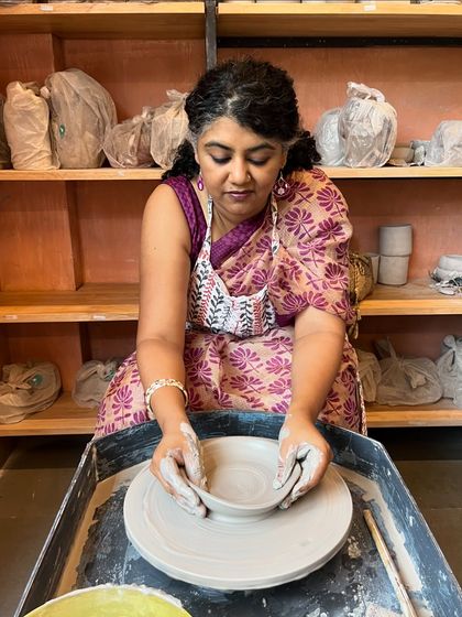 A student gracefully forms a bowl on the wheel, showcasing the elegance and skill that can be developed in our classes.