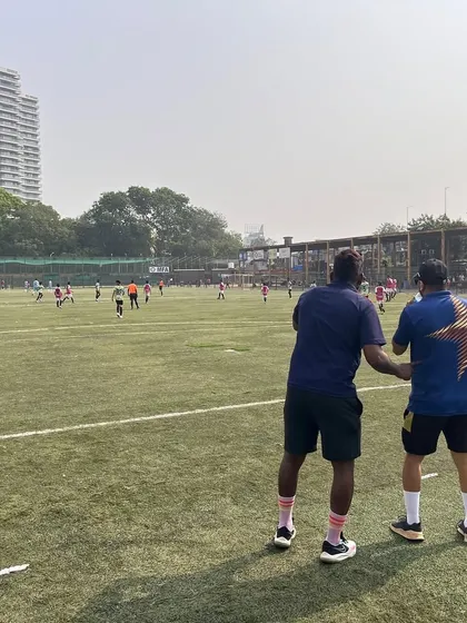 Coaches watching over a U-13 match. Their constant presence and guidance from the sidelines are crucial for the team's performance and development.
