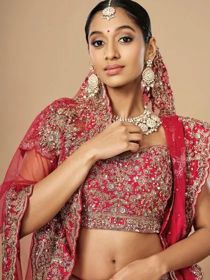 This portrait showcases a confident bride ready for her big day. The makeup is flawless, with defined eyes and a soft lip color that enhances her natural features.