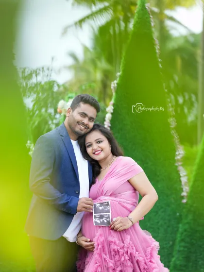 Announcing their joy to the world. This couple holds up their baby's first ultrasound picture, a perfect prop to personalize your maternity photoshoot.
