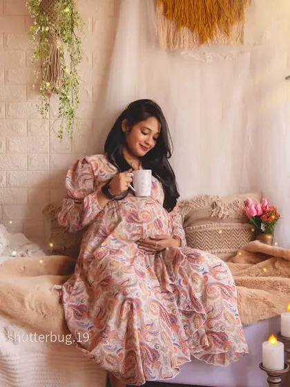 A peaceful moment for the mom-to-be, enjoying a cup of tea in our warm, candlelit boho setting. This portrait captures the calm and comfort of home.
