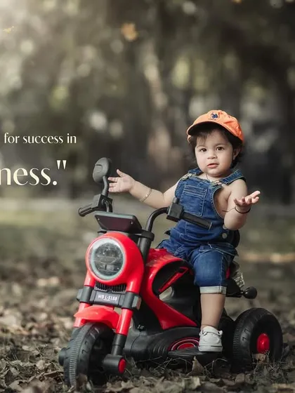 Dressed for success in pure happiness. A confident toddler poses on his toy motorcycle during an outdoor shoot.