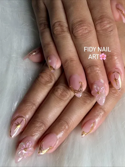 A closer look at FiDi nail art. These delicate, translucent flowers are sculpted directly onto the nail, paired with fine gold line work for an ethereal look.