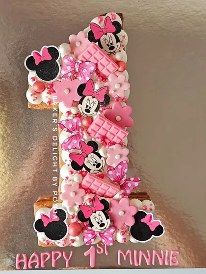 "One in a Minnie!" This Minnie Mouse themed tart, shaped like the number one, is a unique and adorable way to celebrate a first birthday. The butter base is filled with a delicious chocolate mousse.