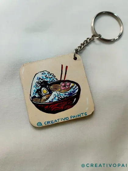This keychain combines two great things: ramen and classic Japanese art. I painted a delicious-looking ramen bowl with a background inspired by Hokusai's "The Great Wave," a perfect custom gift for a foodie.
