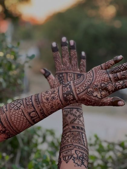 Another angle of the sunset bridal mehendi, showing the intricate patterns on both the front and back of the hands.