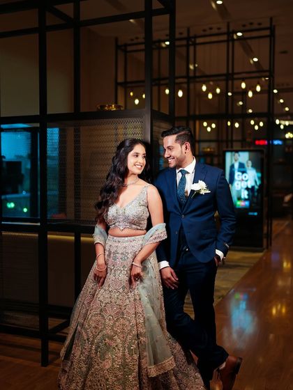 A beautiful couple portrait from the reception. The bride's soft, romantic makeup perfectly complements her elegant lehenga.
