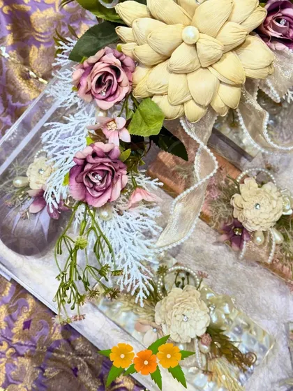 A closer view of the acrylic box, placed on a rich purple brocade fabric. The combination of modern materials and traditional textiles is a hallmark of my style.