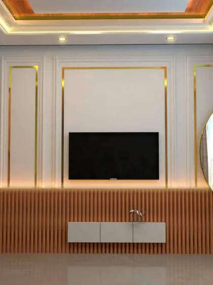 A TV unit design that combines classic and modern elements. We used white and gold molding on the walls, paired with a wooden fluted panel base and a floating console to create a light and airy feel.