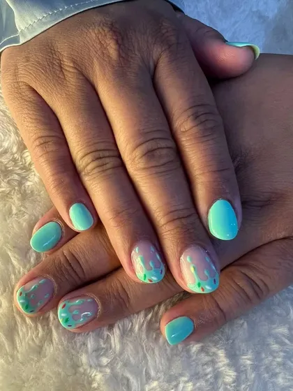 Super cute ice cream nails to welcome the summer. This design features a mint green base with melting ice cream art.