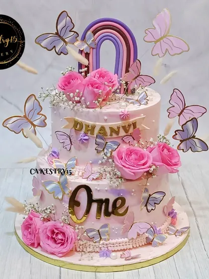 We created this stunning 5kg choco-vanilla cake for a first birthday, featuring real roses, delicate butterflies, and a fondant rainbow. The soft pink and lavender tones make it a truly dreamy centerpiece.