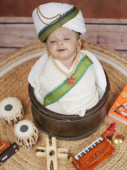 A slightly different angle of our newborn Warkari, showcasing the traditional cap and attire against a rustic, earthy backdrop.