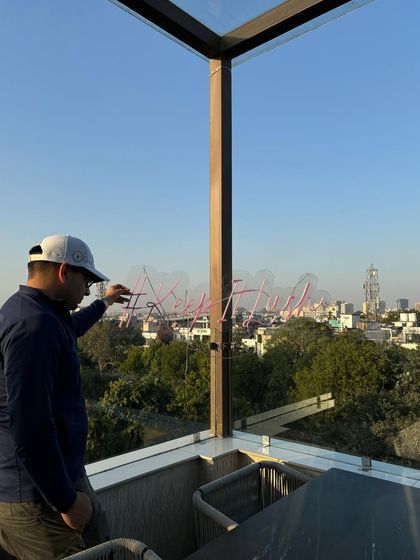 Setting up the signature '#KeepItLush' neon sign against the Delhi skyline. Every detail is considered to make the space feel special and on-brand for the Lush Loft experience.