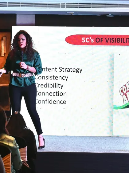 My coaching is built on actionable frameworks like the '5 C's of Visibility': Content, Consistency, Credibility, Connection, and Confidence. Here, I'm presenting this core concept at a leadership program, showing women how to build a personal brand that gets noticed.