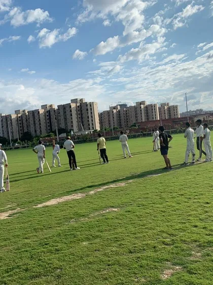 A wide view of the Star Cricket Academy ground on a clear day. You get a spacious, green outfield set against the Noida skyline, ideal for a full day of cricket.