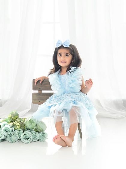 A princess in blue for her third birthday. This simple, elegant setup with a high-key white background lets her beautiful dress and personality shine.