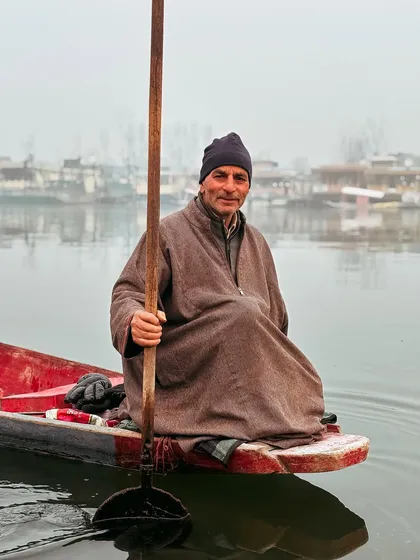 A portrait of a shikara boatman, his face telling a thousand stories. The people are the heart of any destination.