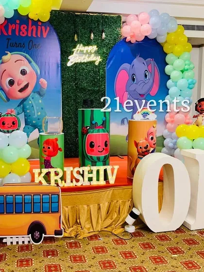 Cocomelon is one of the most requested themes for toddlers. This setup includes a custom backdrop, character cutouts, a colorful balloon arch, and a large marquee 'ONE' to make the first birthday extra special.