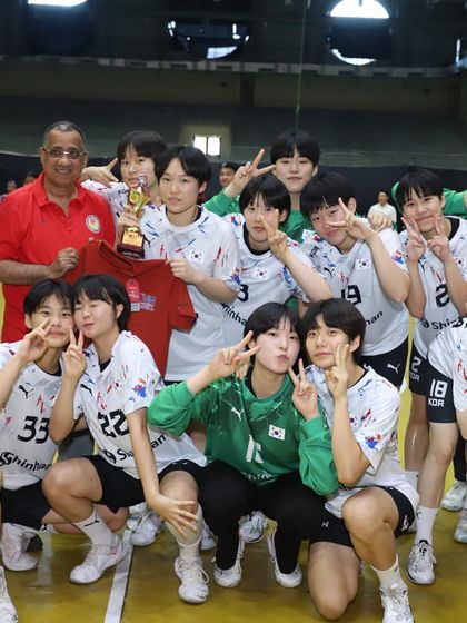 The victorious South Korean team celebrates with their trophy. Our stadium is a venue where international champions are made.