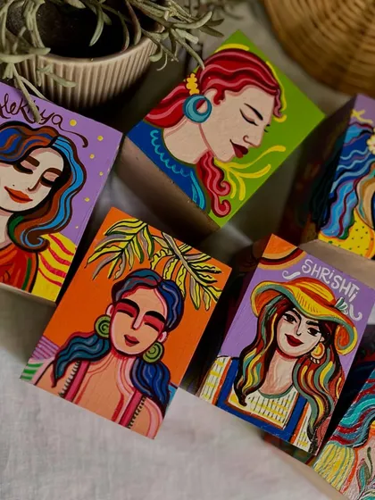 A close-up of the custom pen stands we made for a corporate client, each one featuring a unique portrait.