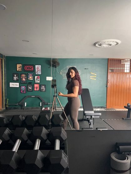 Flexing for the camera. Celebrating the strength and muscle I've worked hard to build.