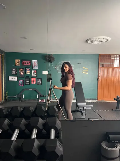 Flexing for the camera. Celebrating the strength and muscle I've worked hard to build.