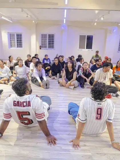 A moment of connection. Instructors Arunn and Divya sit with the students, sharing stories and insights during their Collab session.