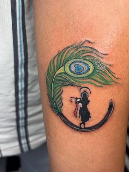 Another angle of the Krishna tattoo, showing how it wraps cleanly on the arm. Placement is key for a tattoo to look its best.