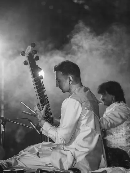 On stage in Nepal with my tabla player in the background. The smoke and lighting add to the mystical atmosphere.