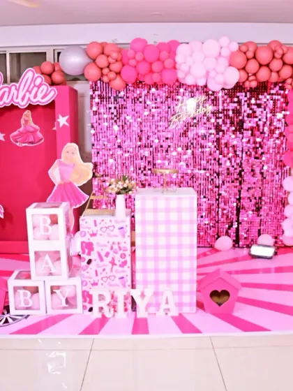 A vibrant and playful Barbie-themed first birthday party. We used shades of pink, a sparkling sequin backdrop, and a life-sized Barbie box prop to create a fun and glamorous world for the birthday girl.