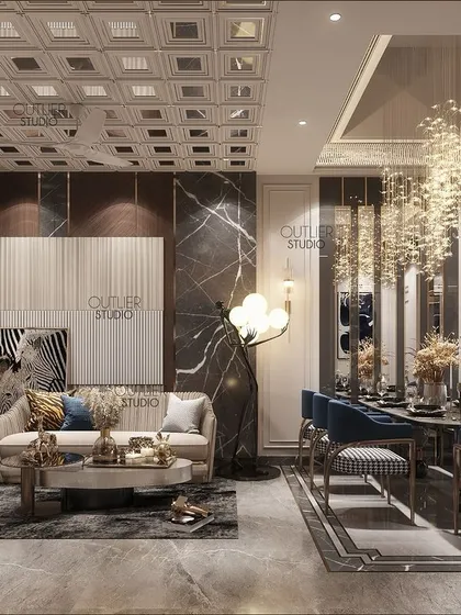 This living and dining area is a world of luxury and sophistication. A double-height dining space with a cascading chandelier is paired with a cozy living area, defined by dark marble and plush seating.