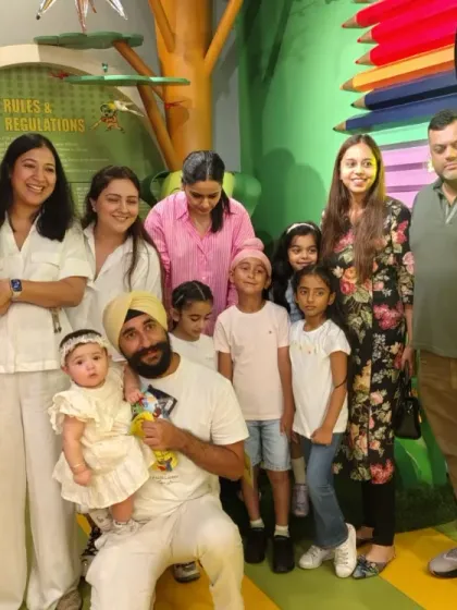 Families and friends come together for a group photo, celebrating a day of fun at Tingaland.